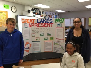 Three student show their Great Lakes Past and Present display. 
